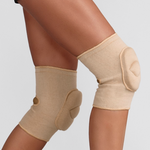 Beige knee pad on a person's leg against a plain background