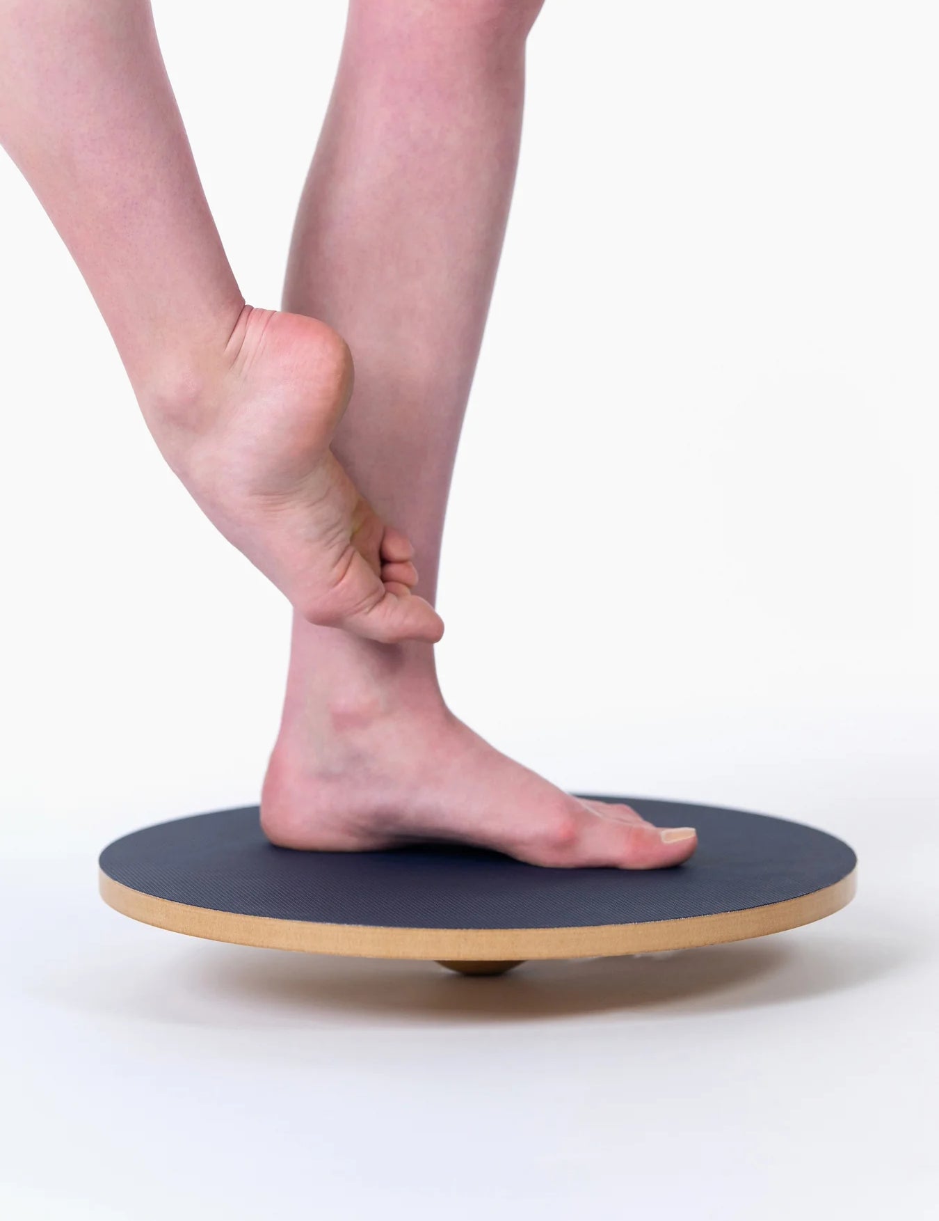 Person using a balance board on a white background