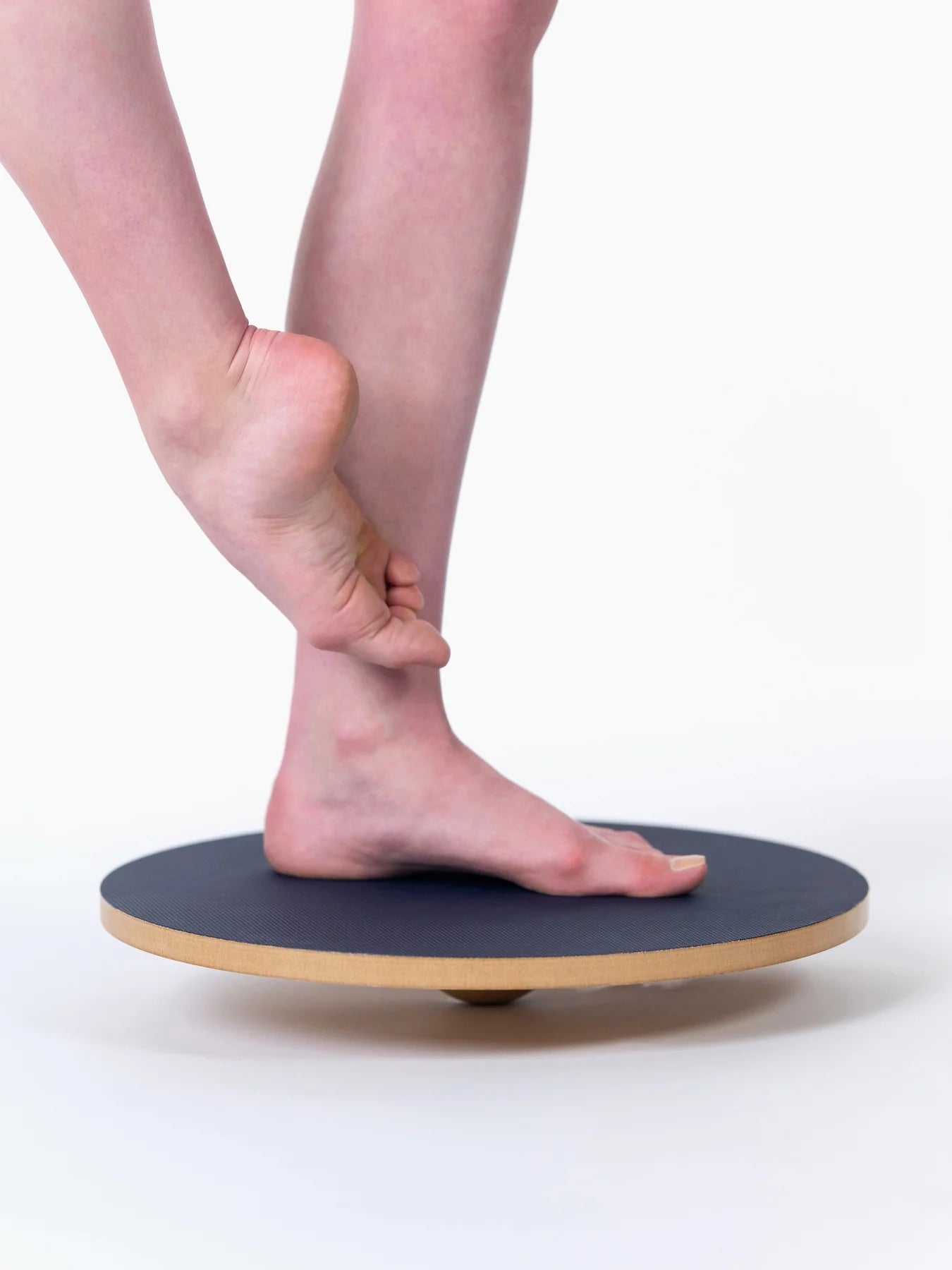 Person using a balance board on a white background