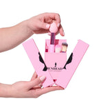 Pink makeup brush set with 'Bunhead' branding held by a hand against a white background