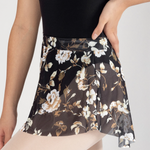 Floral patterned skirt worn by a person on a plain background