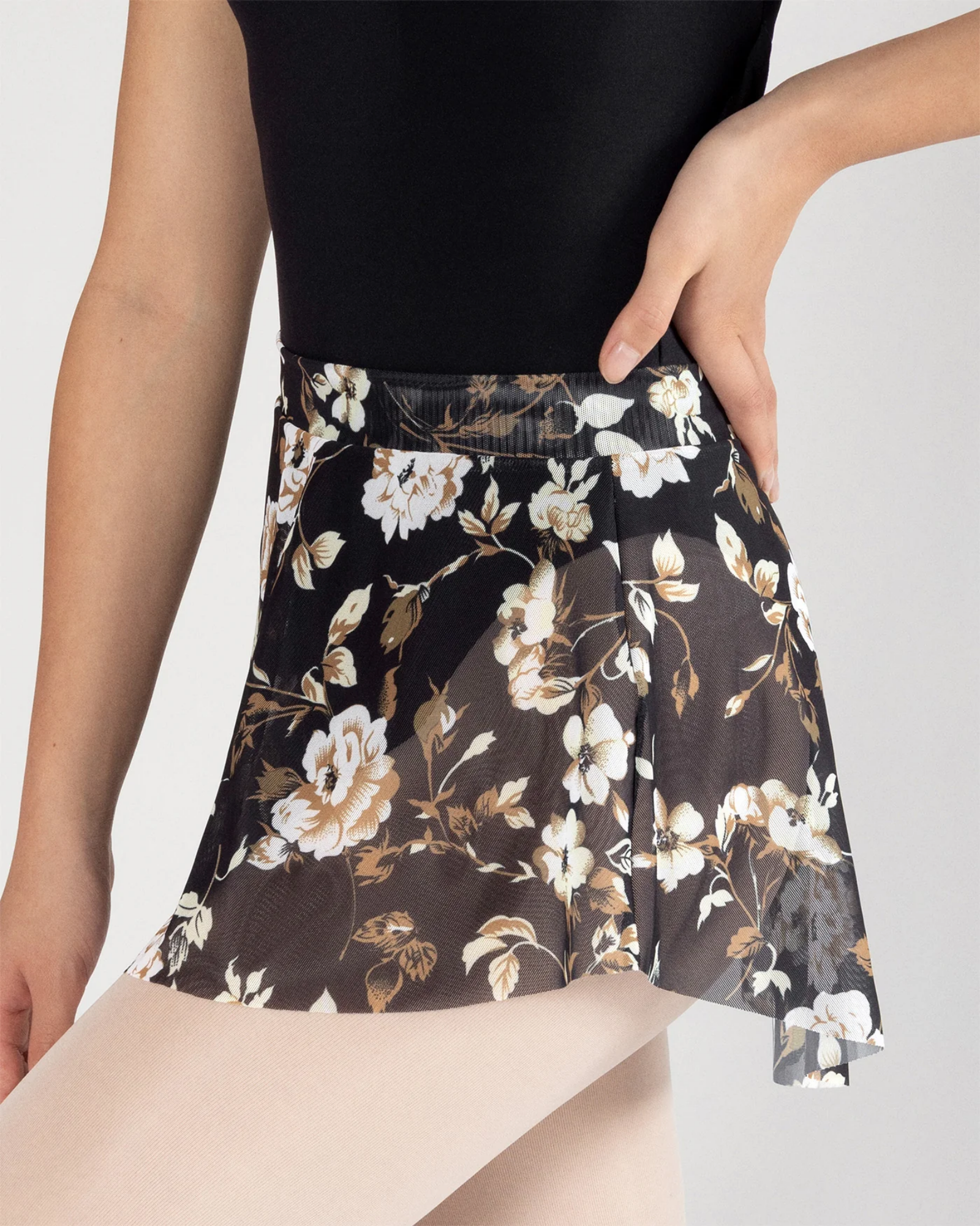 Floral patterned skirt worn by a person on a plain background