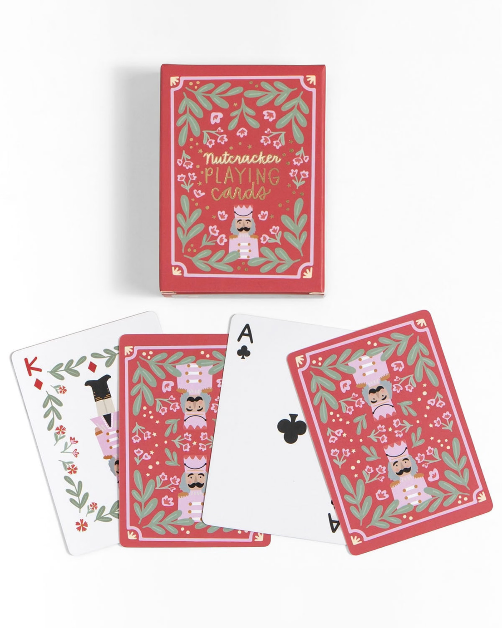 A set of Nutcracker-themed playing cards with a decorative red box and several cards fanned out below, including a King, Ace of Spades, and Ace of Clubs, on a clean white background.