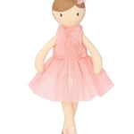 Doll in a pink dress with a bow on a white background
