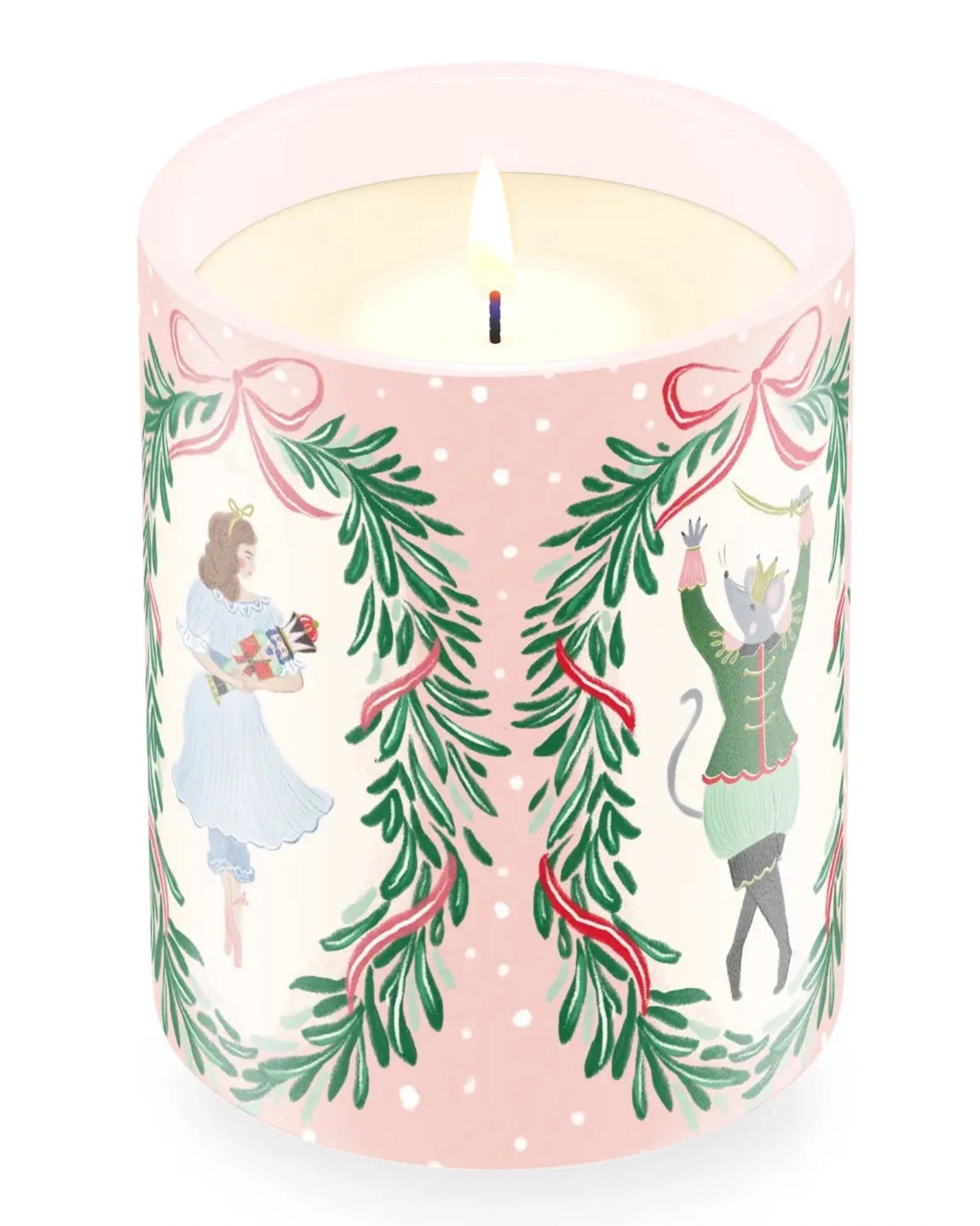 A lit scented candle in a cylindrical glass container with a decorated winter holiday body. The candle features an illustration of a girl in a blue dress and a nutcracker character under green pine garlands with red ribbons on a white background.