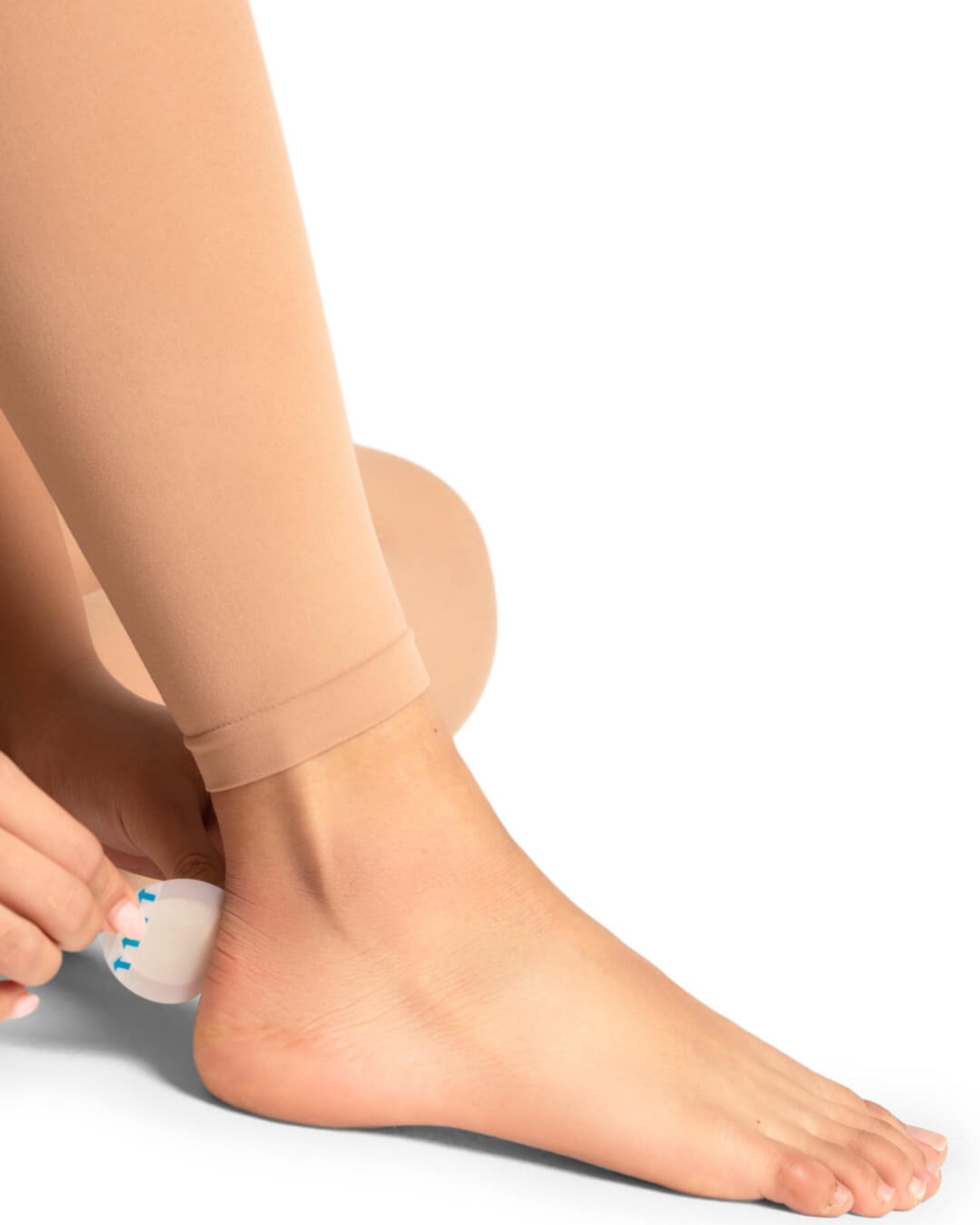 Beige leggings worn by a person on a white background