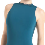 A close-up of a dancer wearing a sleeveless teal blue top with a lace-trimmed mock neck, shown against a plain white background.