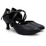 Pair of black dance shoes with a small heel on a white background