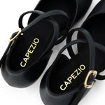 Black dance shoes with 'Capezio' branding on a white background