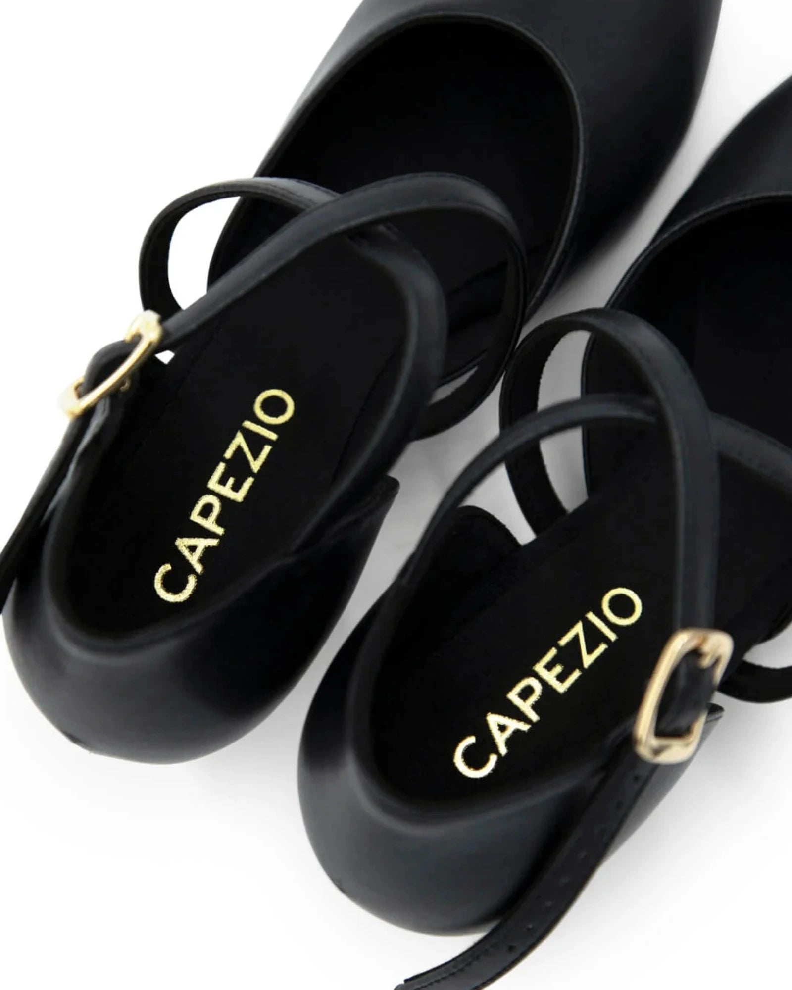 Black dance shoes with 'Capezio' branding on a white background