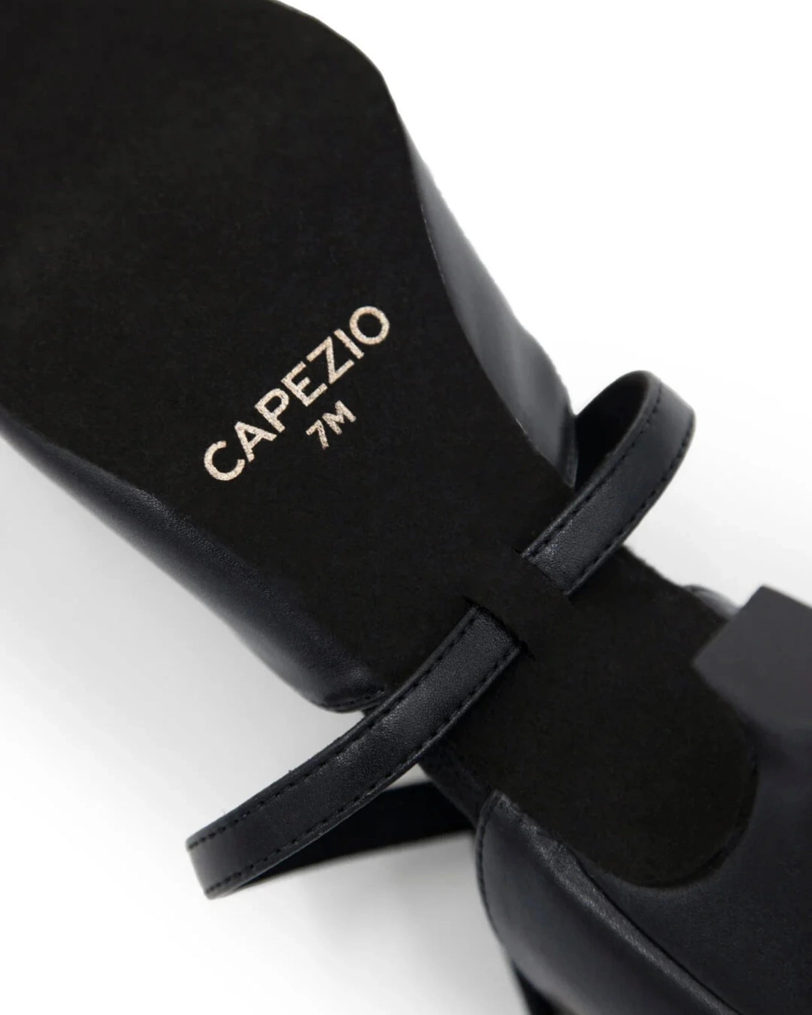 Black ballet shoe with 'Capezio' branding on a white background