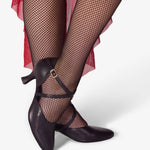 Black high-heeled shoes with fishnet stockings on a white background