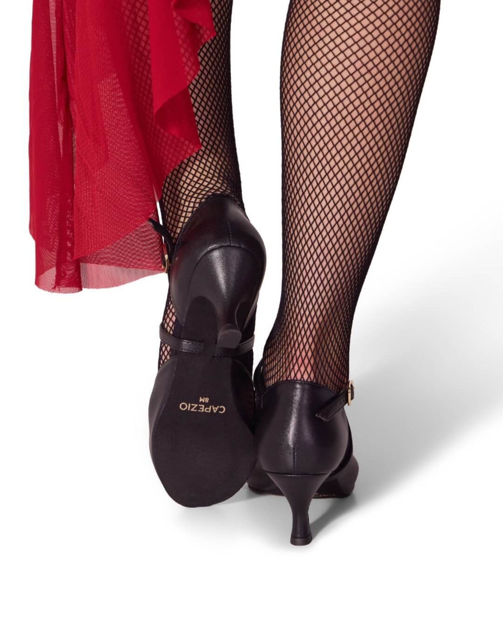 Black shoes with a visible brand logo worn with fishnet stockings and a red skirt.