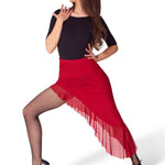 A woman modeling a red high-waisted tango skirt with a sheer ruffled hem, paired with a black top, fishnet tights, and black heels, posed against a solid white background.