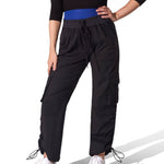 Person wearing black high-waisted pants with a blue belt on a white background