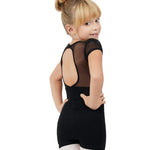 A young girl with blonde hair in a bun is shown from the back wearing a black short-sleeve leotard with sheer mesh back panels and white tights, set against a plain white background.