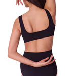 Person wearing a black leotard on a white background