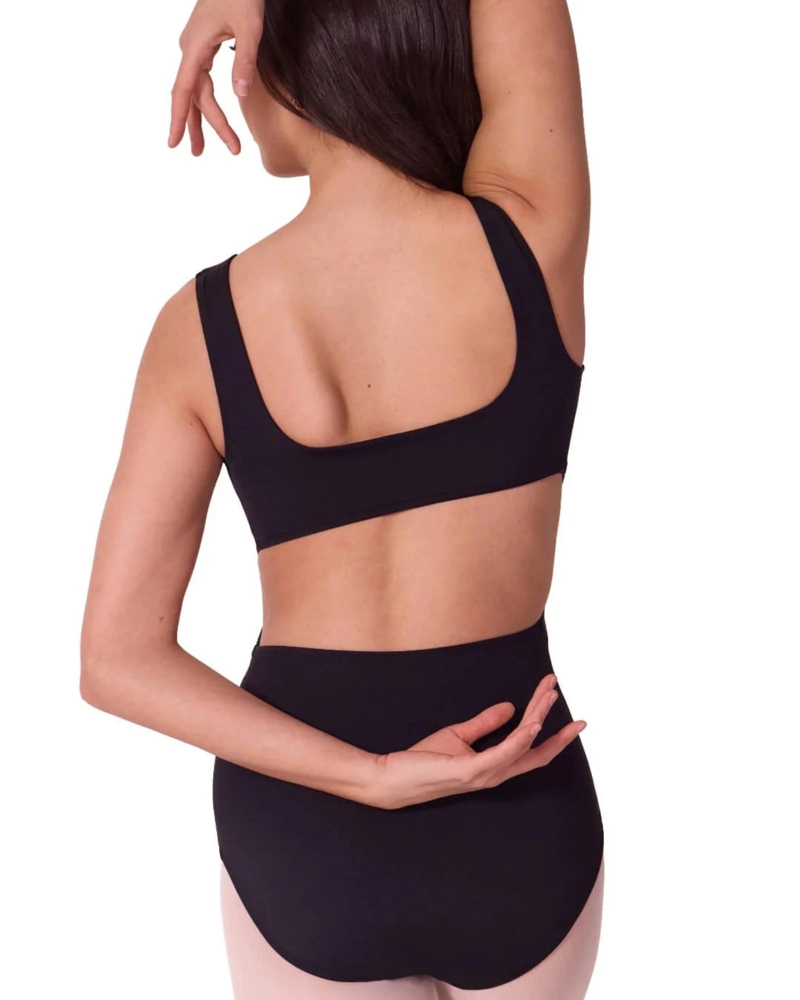 Person wearing a black leotard on a white background