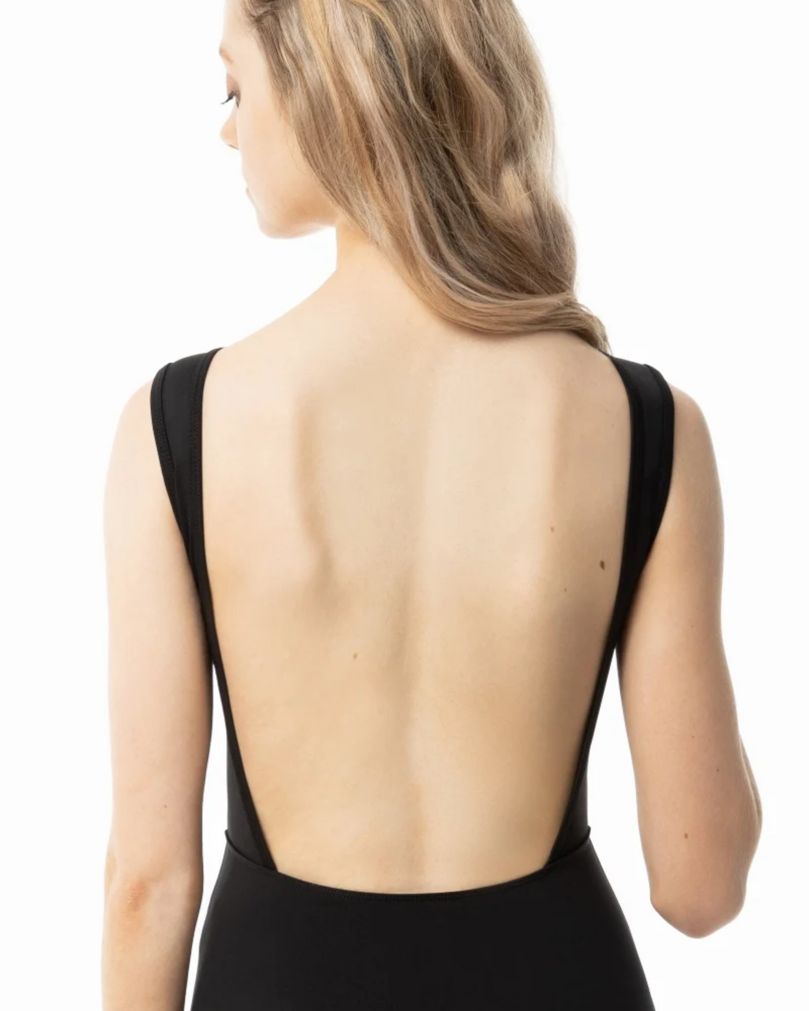 A woman shown from the back wearing a black sleeveless leotard with a very open back, against a plain white studio background.