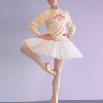 Ballerina in a white tutu and beige sweater with text on a light purple background