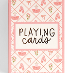 A boxed set of playing cards with a pink and white ballet-themed pattern, featuring illustrations of ballet slippers, tutus, bows, and flowers, with the words 'PLAYING cards' printed on the front.