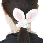 Person wearing bunny ears with a white background