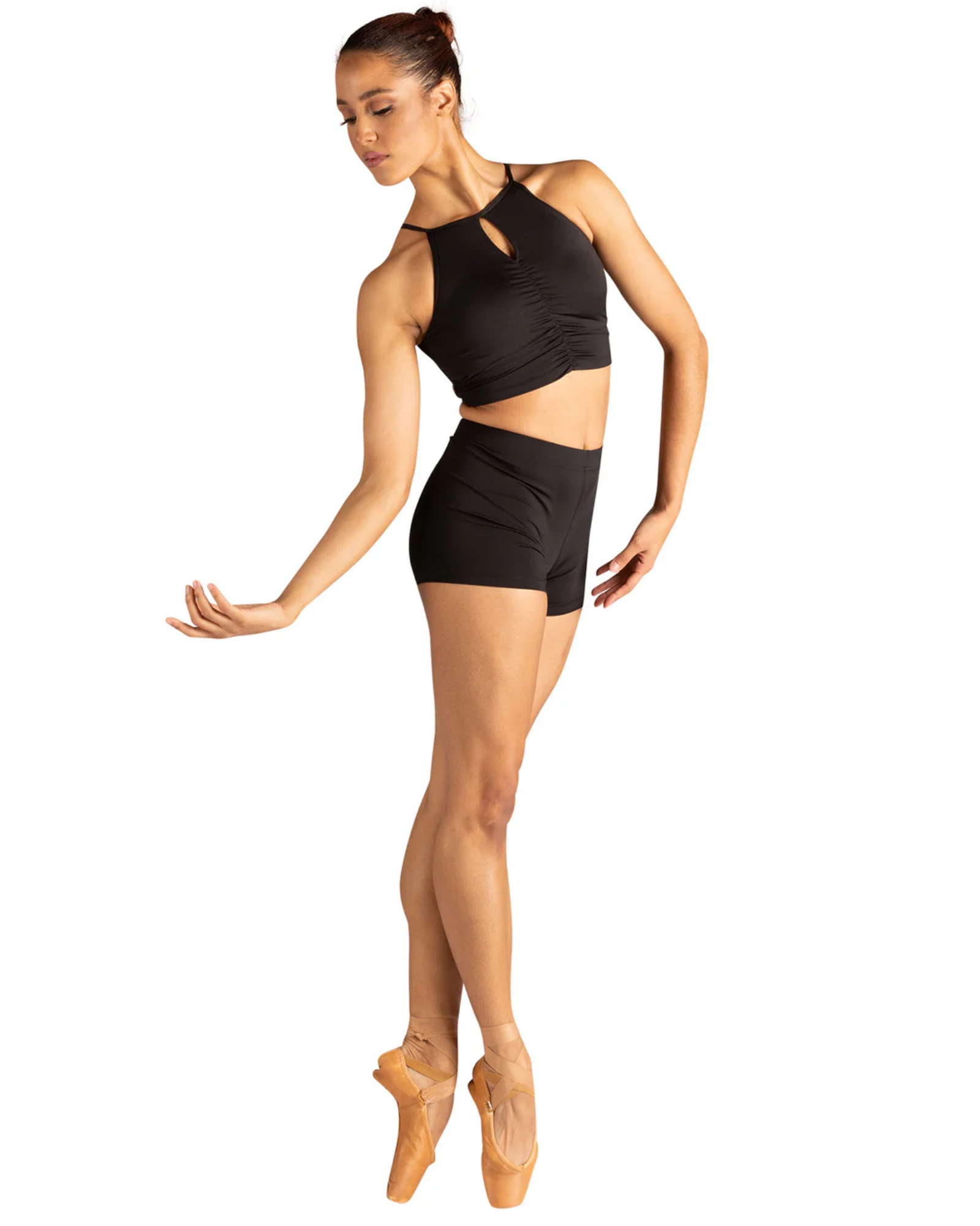 Dancer in a black dance top and shorts on a white background