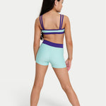 A girl modeling a two-piece activewear set from the back, featuring a mint green  bra top with blue straps and matching high-waisted mint green shorts with a purple waistband, set against a plain light gray background.