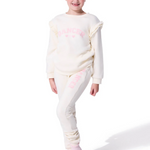 Young girl wearing a white outfit with pink accents on a white background