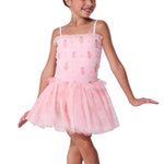 Young girl wearing a pink ballet dress with strawberries on a white background