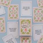 A flat-lay arrangement of square dance cards with pink floral and green leaf illustrations on a light blue background. The cards feature various dance and fitness quotes, including 'Dance like you're stuck in super slow motion' and 'Move only your upper body for 8 counts.