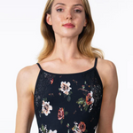 Woman wearing a black floral lace top against a white background