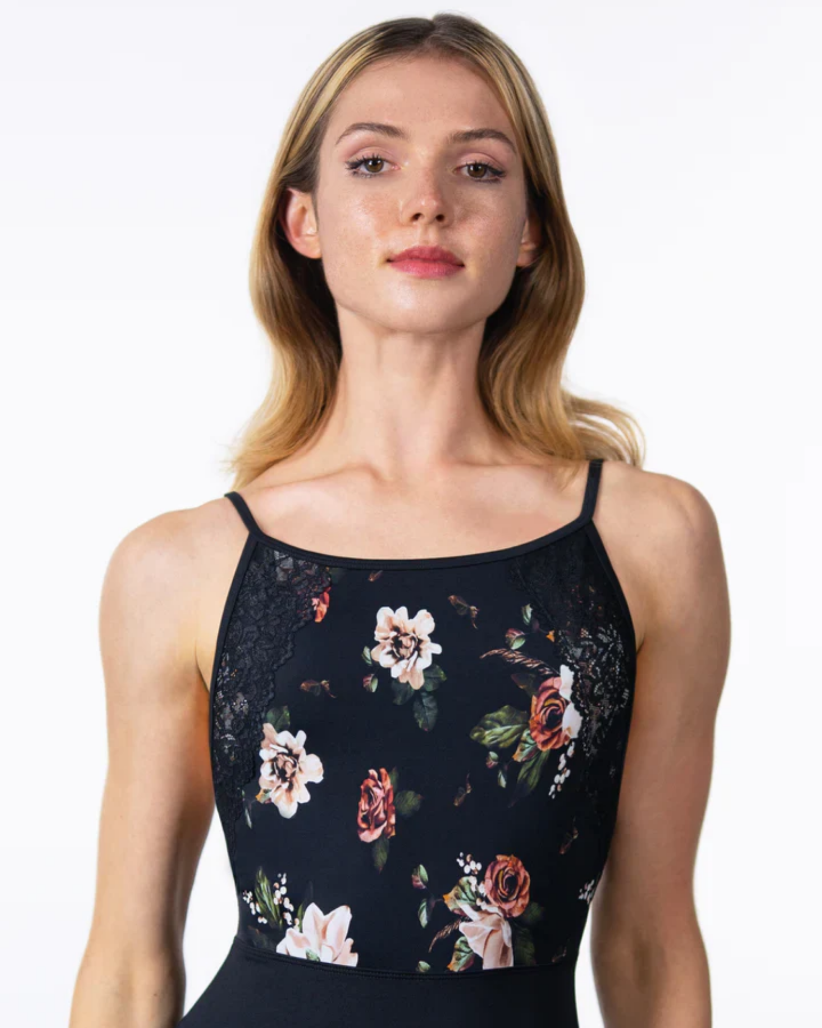 Woman wearing a black floral lace top against a white background