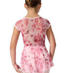 Person wearing a pink floral leotard dress on a white background