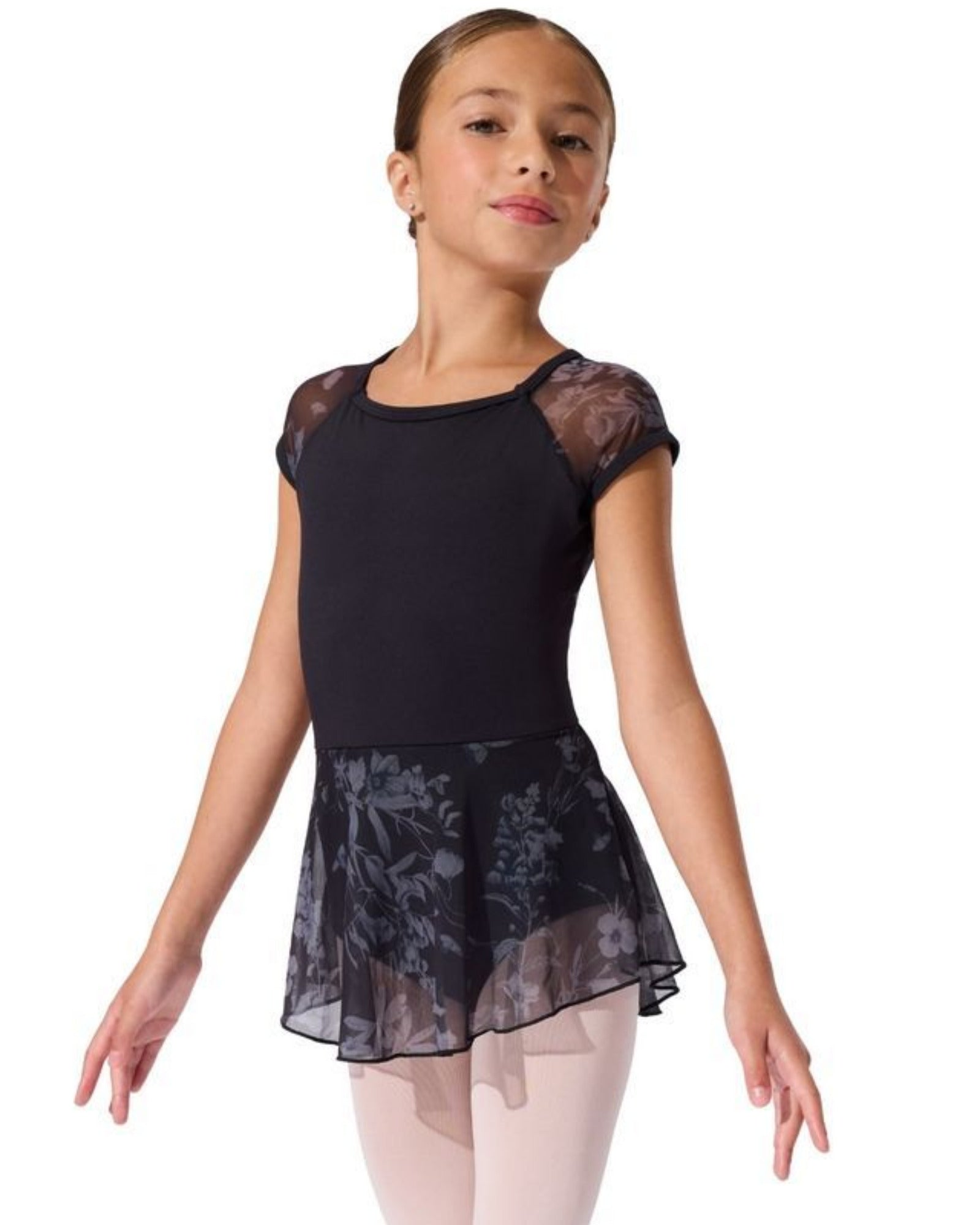 Young girl wearing a black ballet outfit with floral lace skirt on a white background