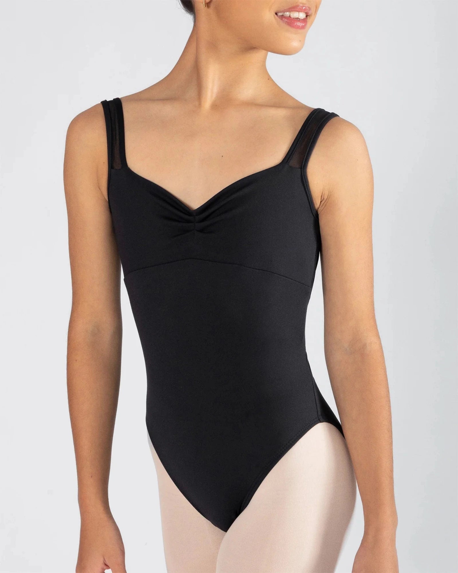 Black leotard worn by a model on a plain background