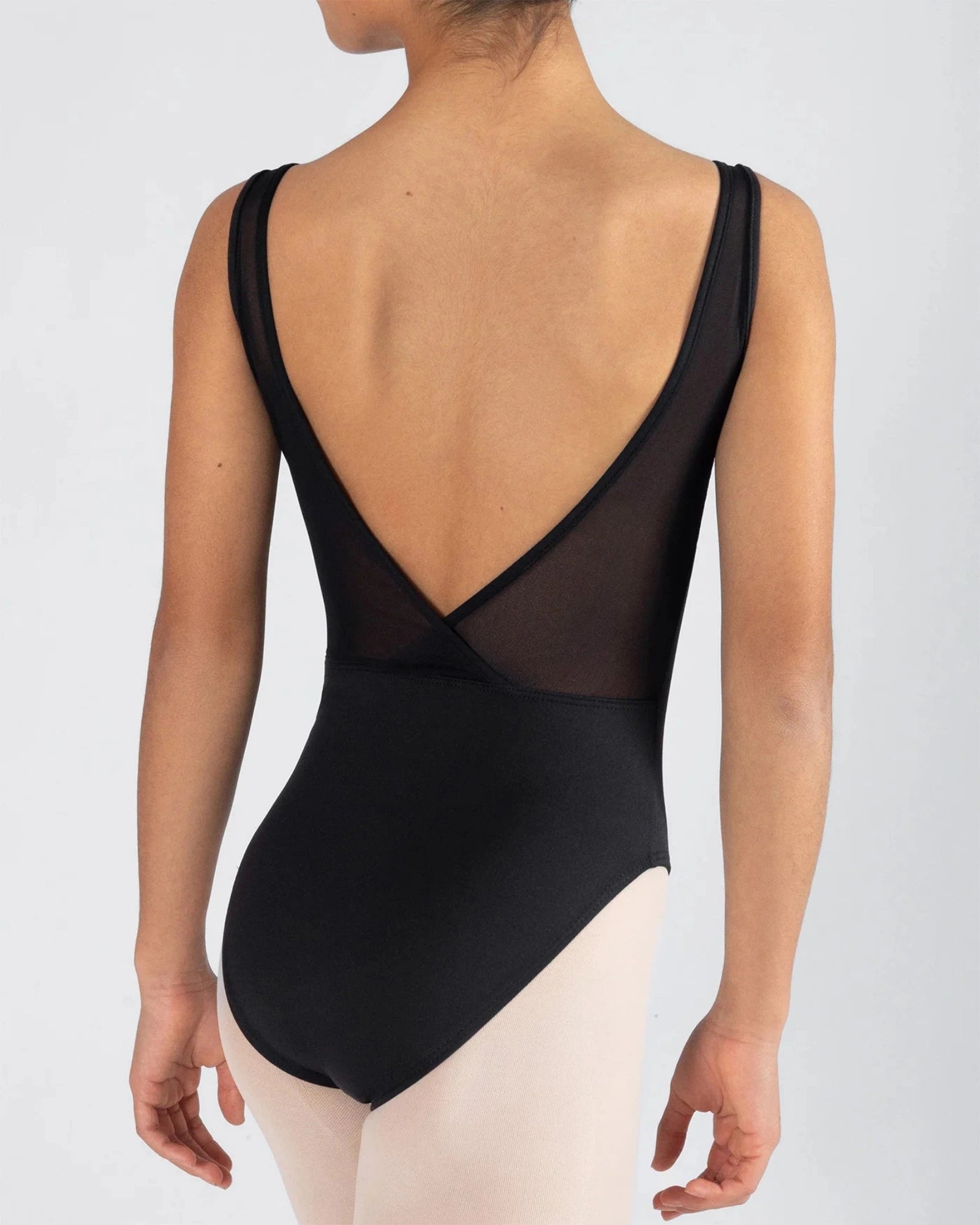 Black leotard with sheer back panel worn by a person on a light gray background