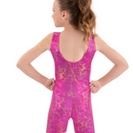 Girl wearing a pink and gold patterned biketard on a white background