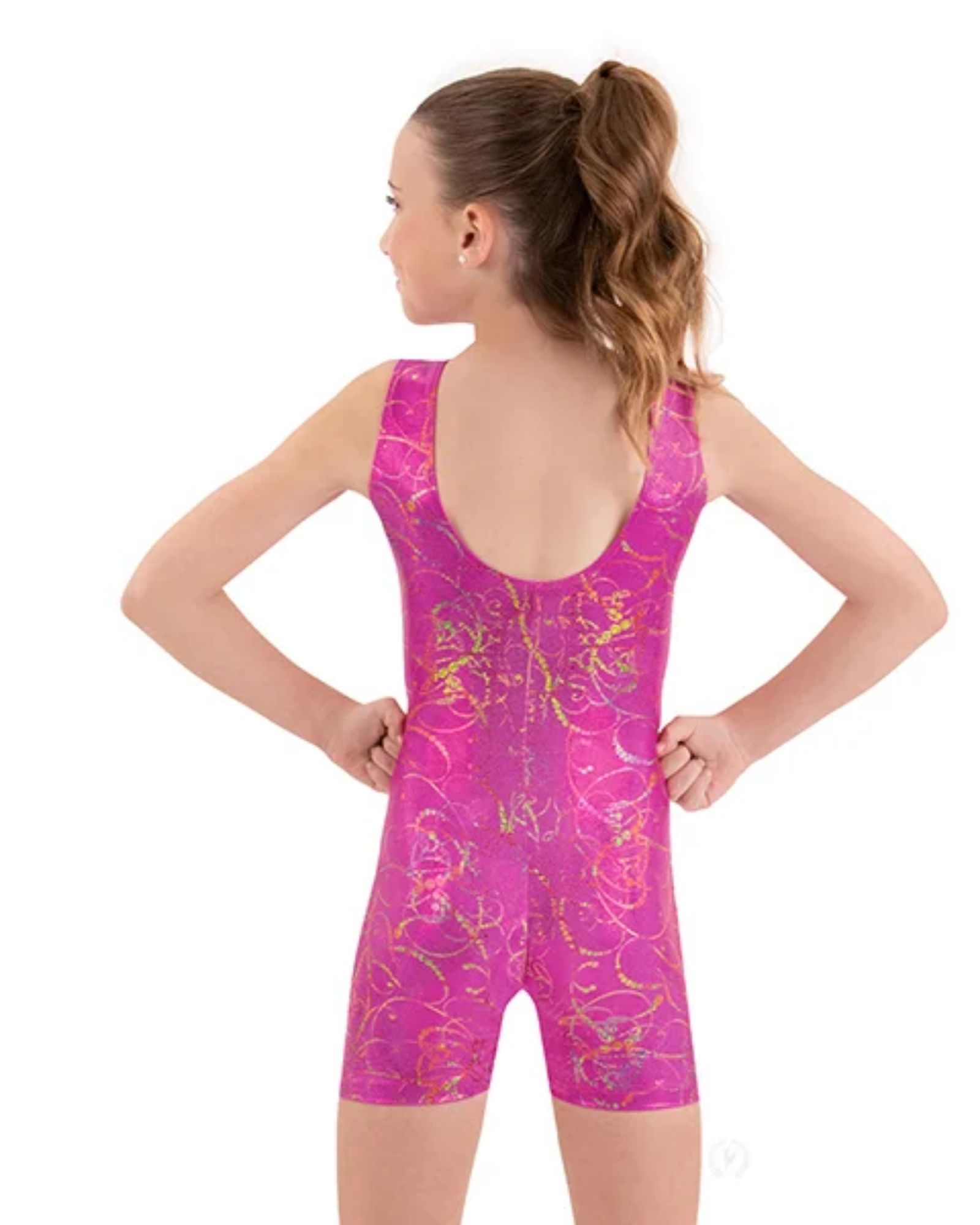 Girl wearing a pink and gold patterned biketard on a white background