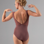 Woman wearing a maroon leotard against a gray background