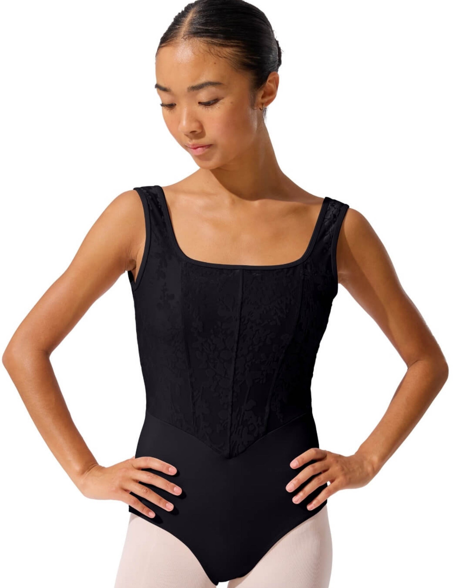 Woman wearing a black leotard on a white background