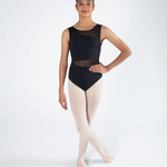 A young ballerina model wearing a black sleeveless leotard with sheer mesh panels and light pink tights, standing in a ballet position against a light gray studio background.