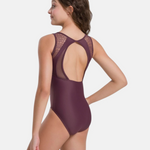 Model wearing a maroon leotard with mesh details on a white background