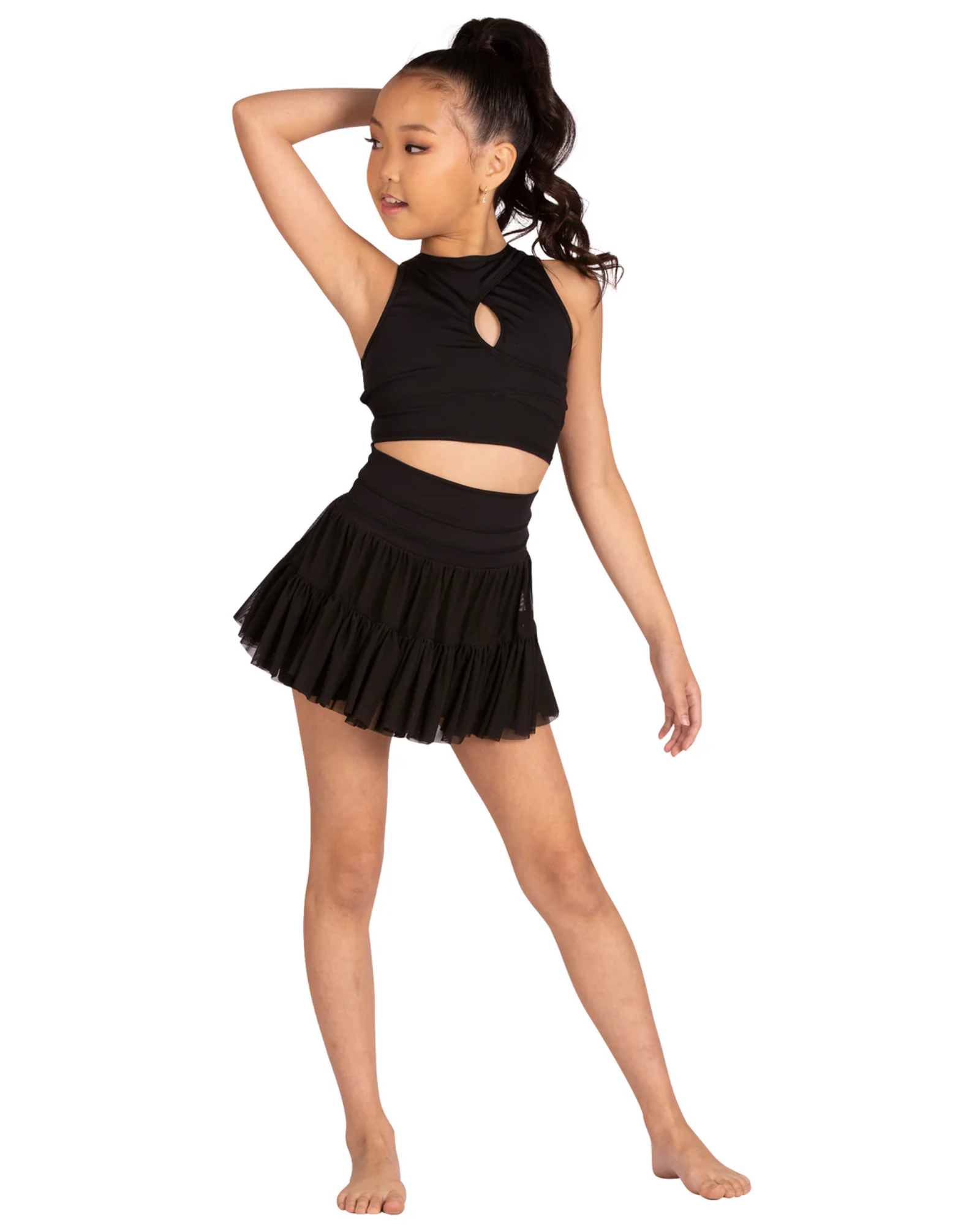 Young girl wearing a black dance outfit on a white background