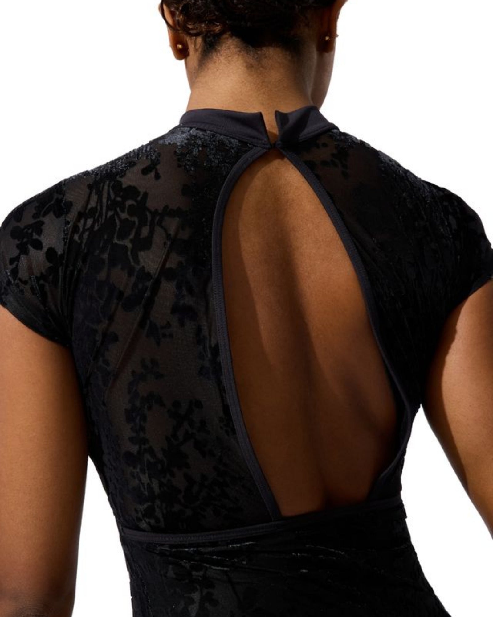 Black floral leotard with open back on a white background