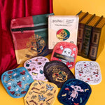 Collection of Harry Potter-themed pouches and books on a yellow background
