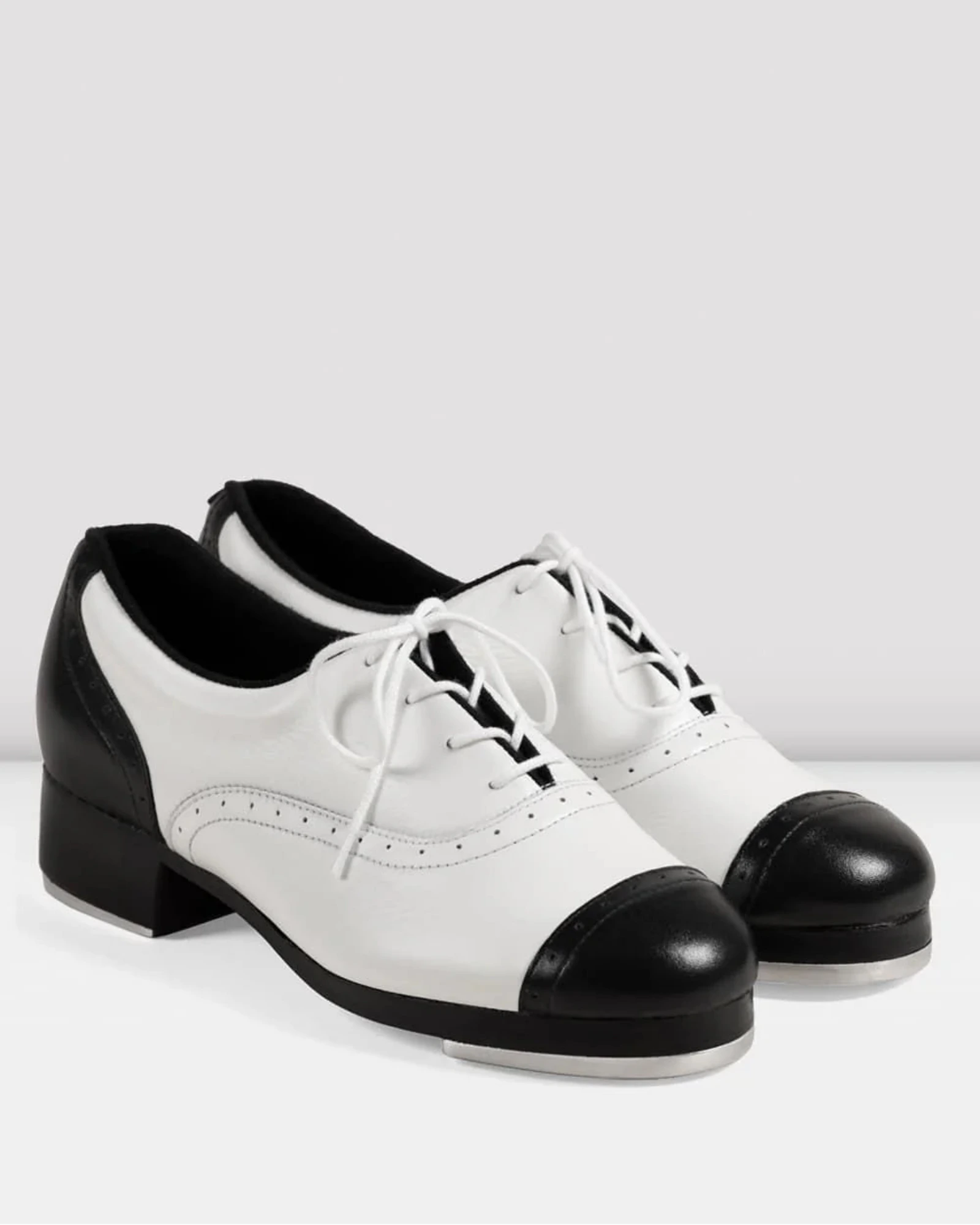 White and black shoes with a block heel on a white background