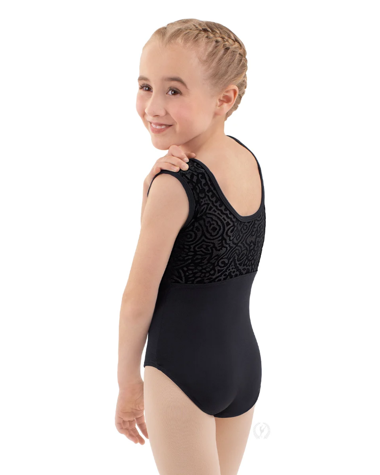 A young girl with blonde braided hair is shown from the back wearing a black sleeveless leotard with a textured lace-like pattern across the upper back and shoulders, set against a plain white background.