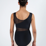A dancer viewed from the back wearing a black sleeveless leotard with sheer mesh panels and light beige tights, set against a plain light gray studio background.