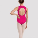 A young girl dancer shown from the back wearing a bright pink sleeveless leotard with a large open back and light pink tights, standing against a light gray studio background.